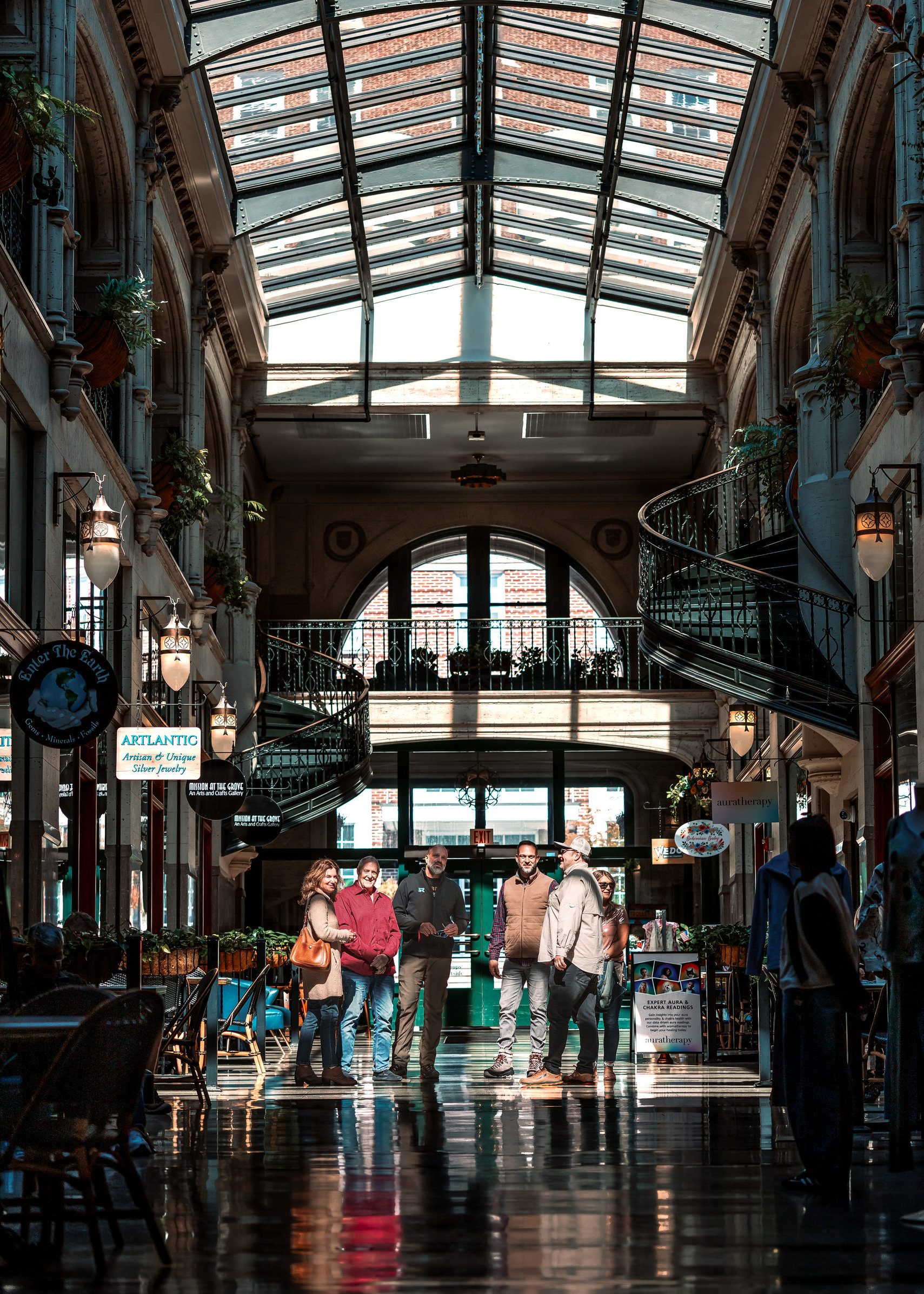 Your guide and your group, indoors and out of the weather, under a barrel-vaulted glass roof.