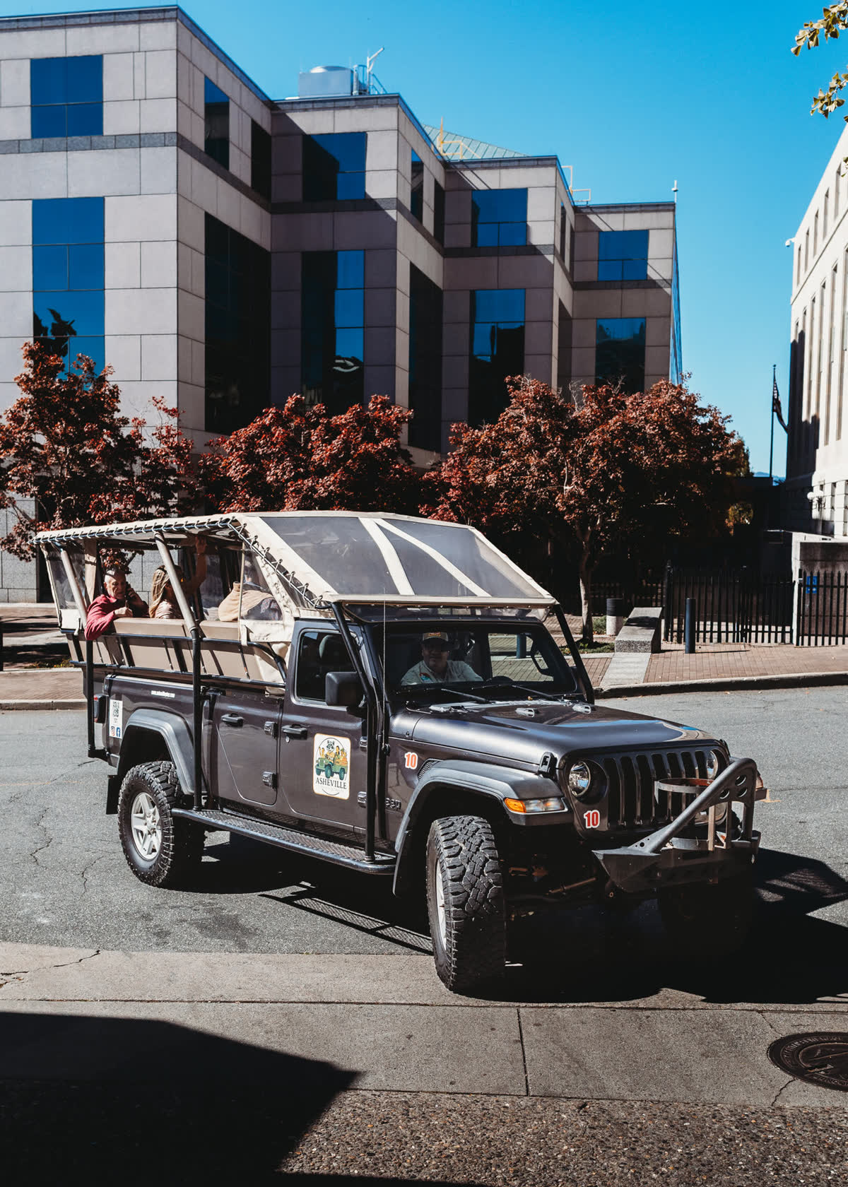 Mid-tour on a downtown street, guests aboard and the guide at the wheel.