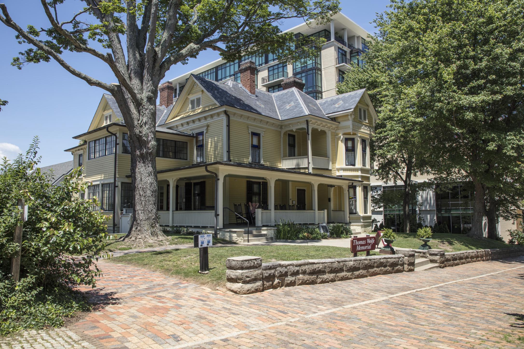 The Thomas Wolfe Memorial - the boarding house at the centre of literary Asheville, with a modern tower standing directly behind it.