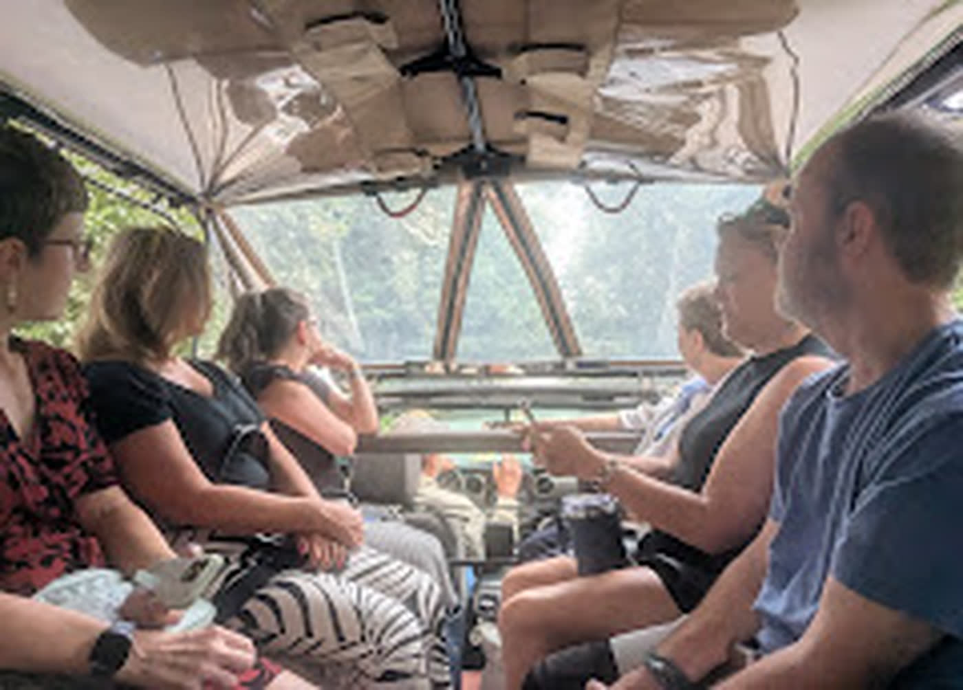 Guests riding under the open canopy of the Asheville Tours military transport