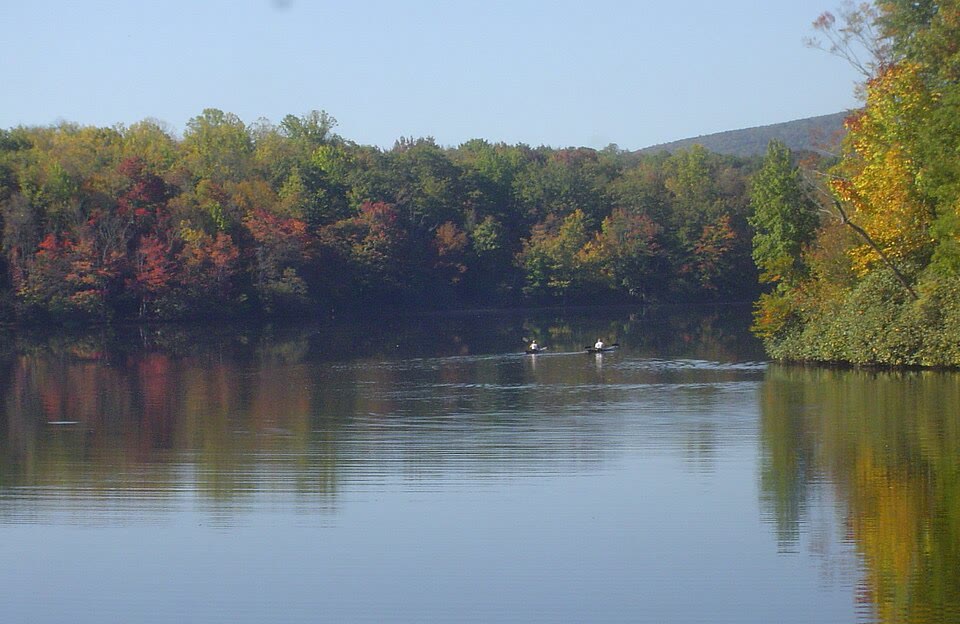 Julian Price Memorial Park, NC. Canoes on 47-acre Price Lake with a ridgeline reflected end-to-end in flat water at dawn.