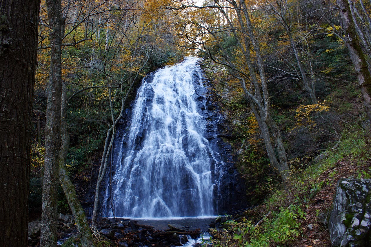 Crabtree Falls, NC. A broad veil of water fanning down a dark angled rock face into a shallow pool, hemlock closing in.