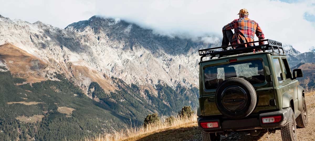 Open-air Jeep Wrangler on a mountain road