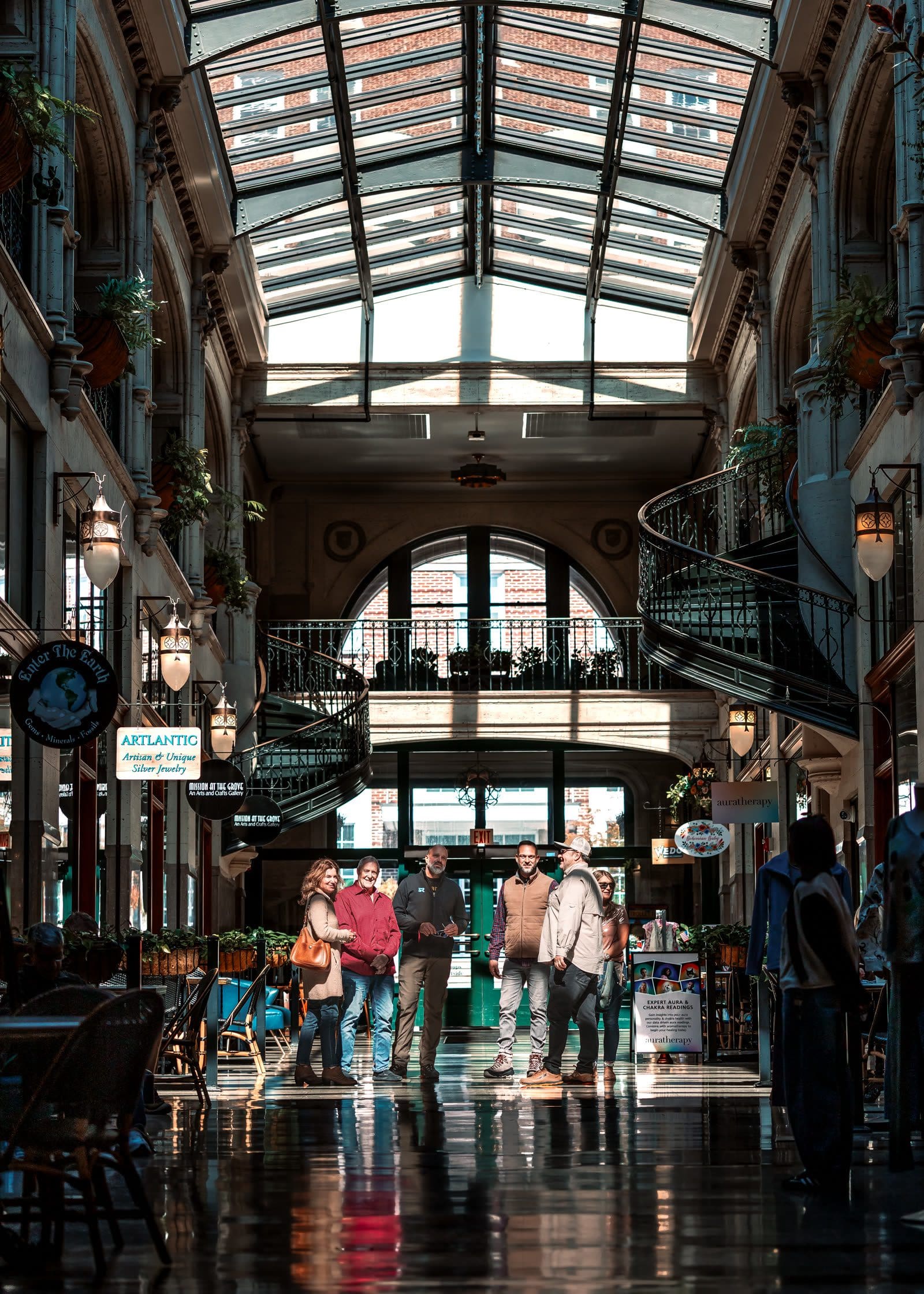 A group of guests together inside the Grove Arcade in downtown Asheville during a city tour stop
